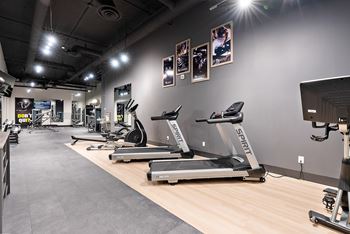 A gym with treadmills and exercise equipment.